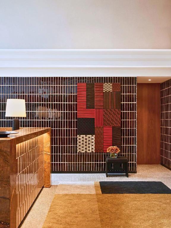 A compact reception area with patterned wall art and warm geometric finishes.