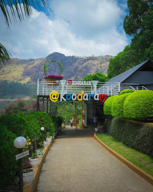 a walkway with a sign that reads koococoa at Koodaram Camping Munnar in Munnar