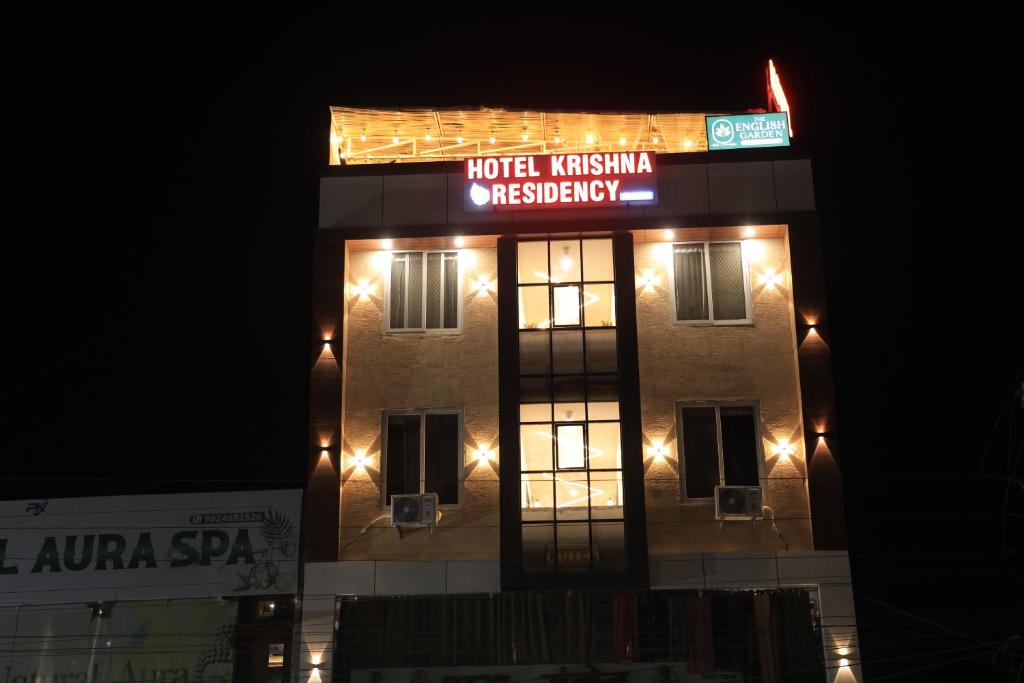a building with a sign on top of it at night at Hotel Krishna Residency in Udaipur