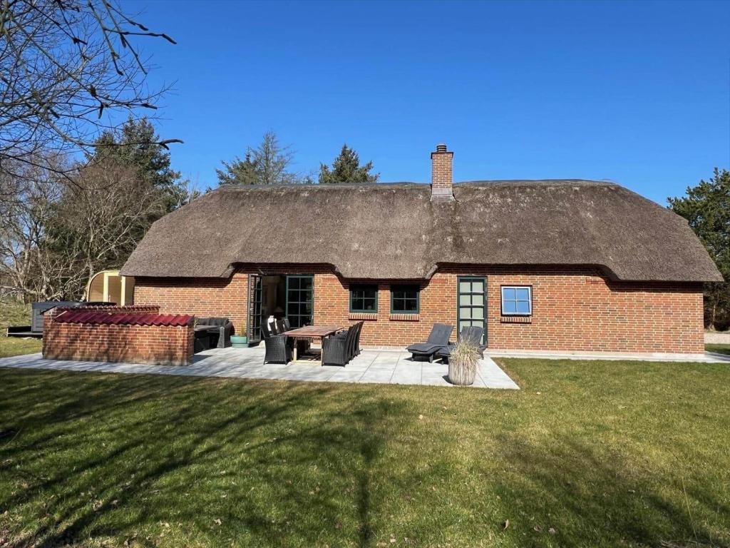 a large brick house with a thatched roof at 10735-Ulfborg-Graevlingevej-11 in Ulfborg