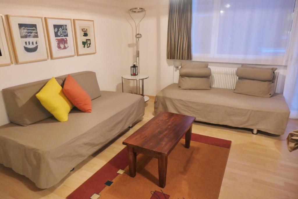 a living room with a couch and a coffee table at Haus Silberblick Anrig in Grächen