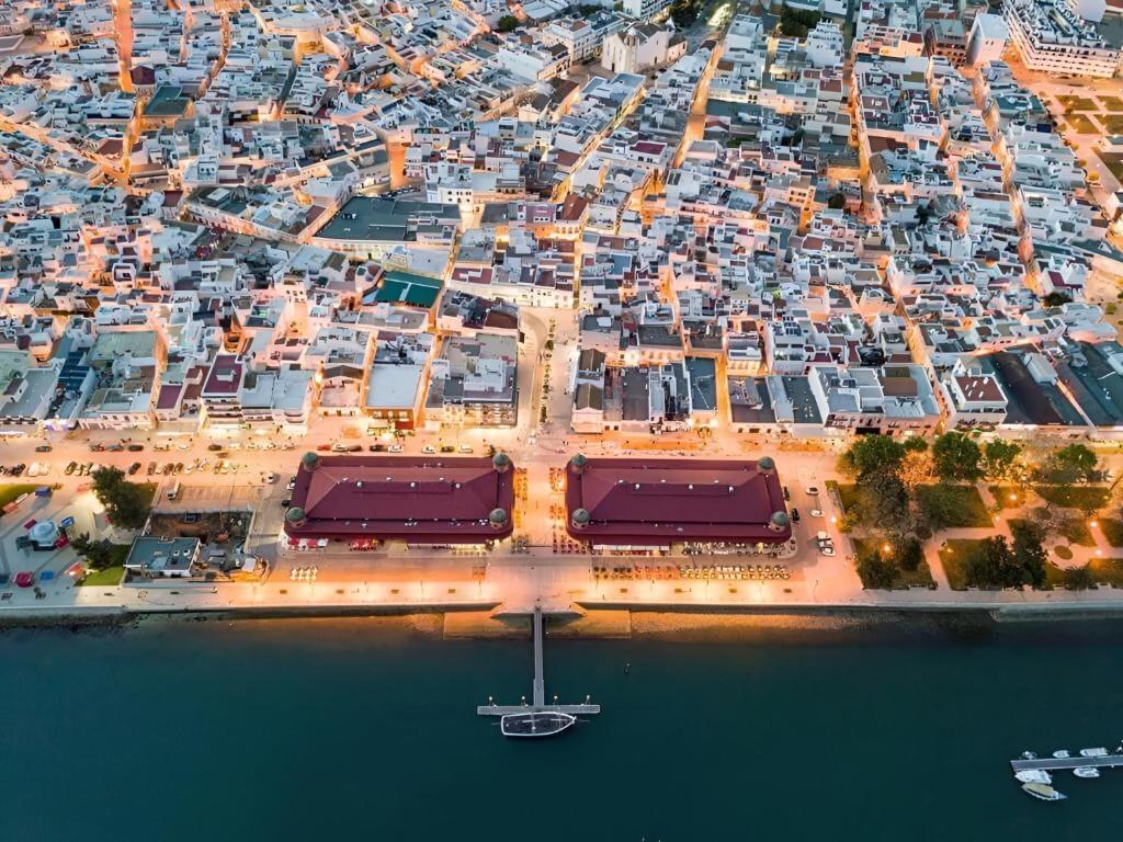 an aerial view of a city with a harbor at Central Olhão, 2min Island Ferry, Pool, Private Parking in Olhão