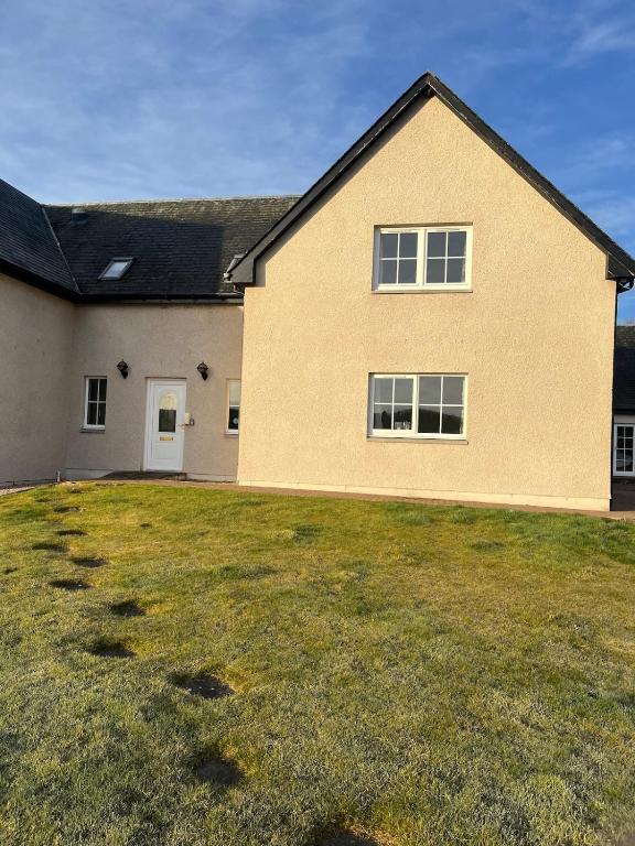 a house with a large yard in front of it at Ardbrae Apartments in Daviot