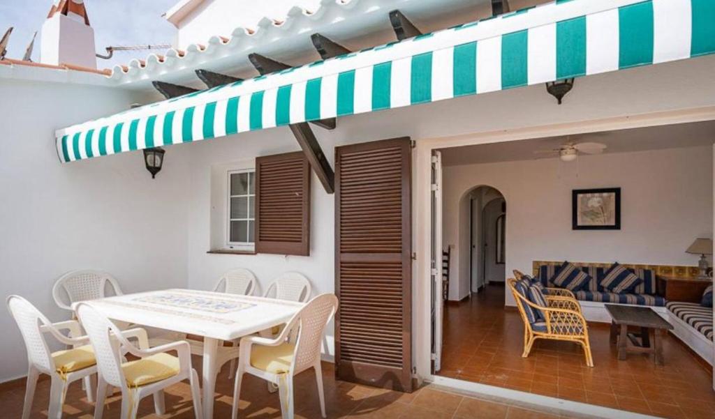 a dining room with a table and chairs at Apartment for 6 with a private terrace in Son Bou in Son Bou