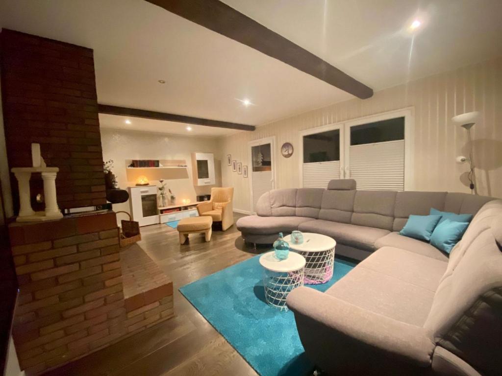 a living room with a couch and a table at Haus Rosenwind in Wangerland
