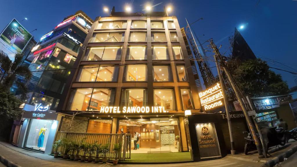 a large building on a city street at night at Hotel Sawood International in Kolkata