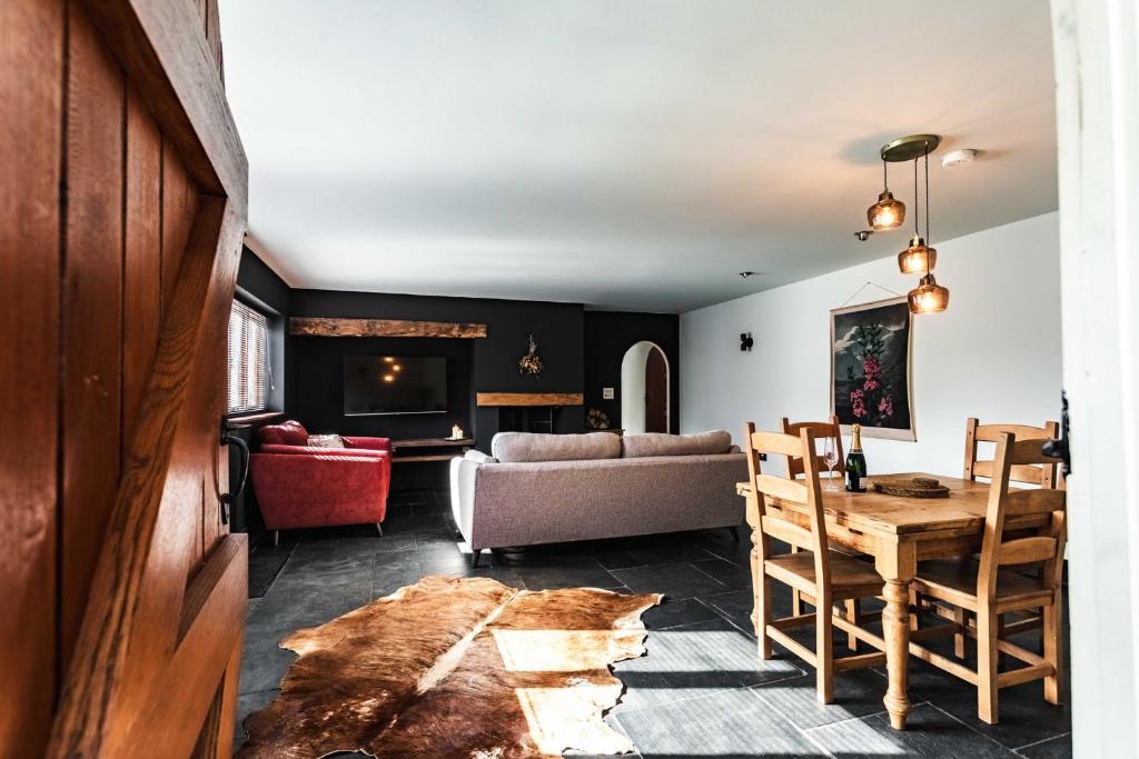 a living room with a table and a couch at New House Barn in Ashbourne