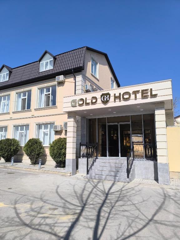 a building with a sign that reads old hotel at Gold Hotel Quba in Quba