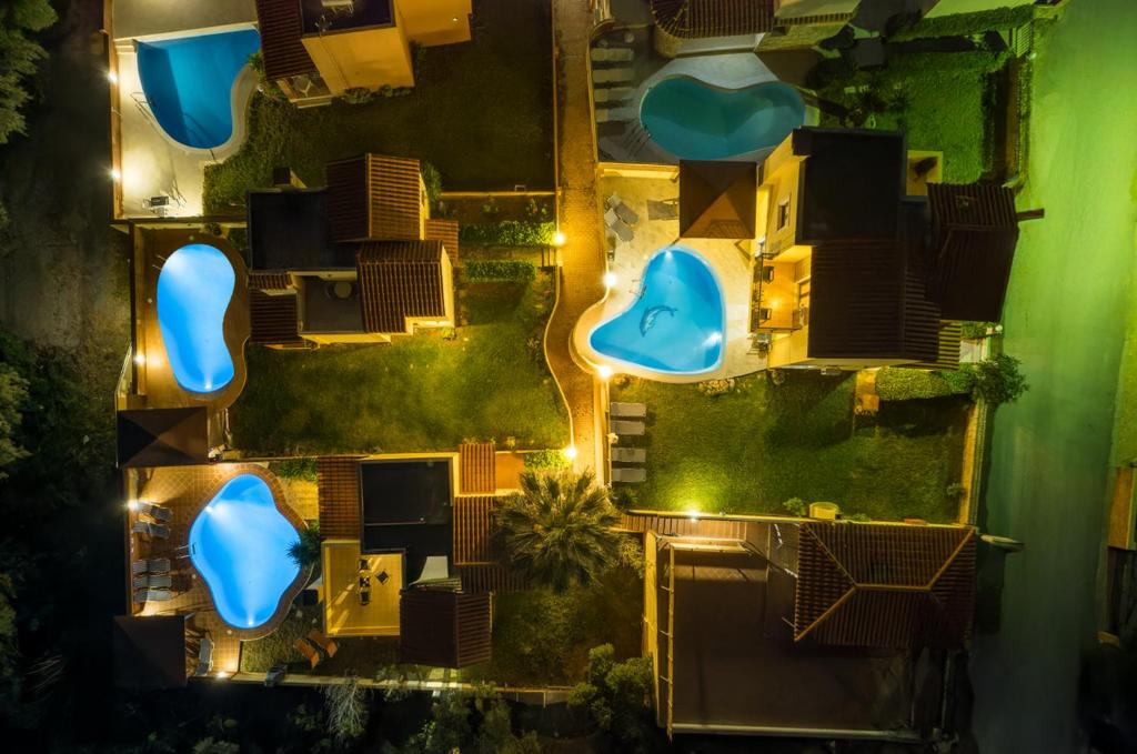 an overhead view of a backyard at night with blue swimming pools at Hersonissos Villas in Hersonissos