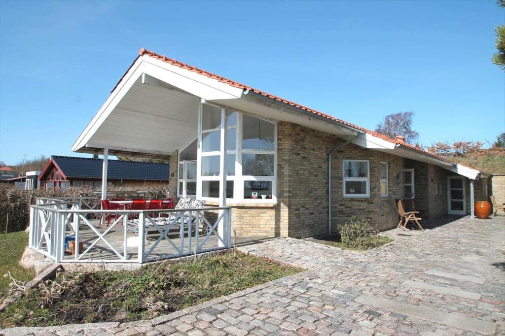 a brick house with a large window and a patio at SL245-Rude-Fuglevaenget-20 in Rude