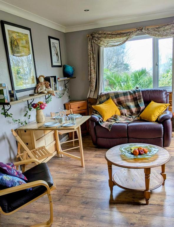 a living room with a couch and a table at White Pebbles Appartment in Ilfracombe
