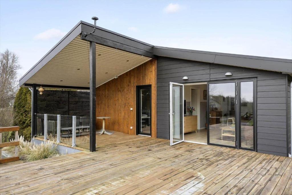 a building with a wooden deck with a house at SL343-Slagelse-Bygvangen-7 in Strandlyst