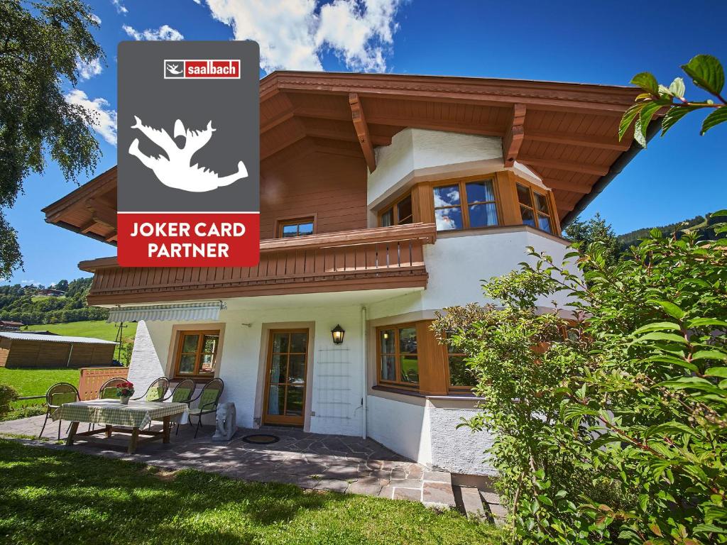 a house with a sign that reads lower card partner at Chalet Felix by we rent, JOKERCARD INCLUDED in Saalbach-Hinterglemm