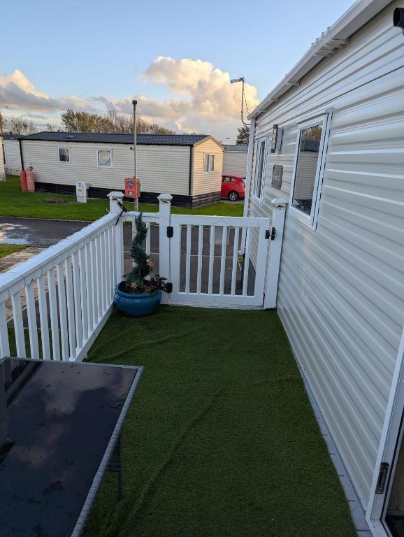 a patio with a white fence next to a building at Arnside abode in Morecambe