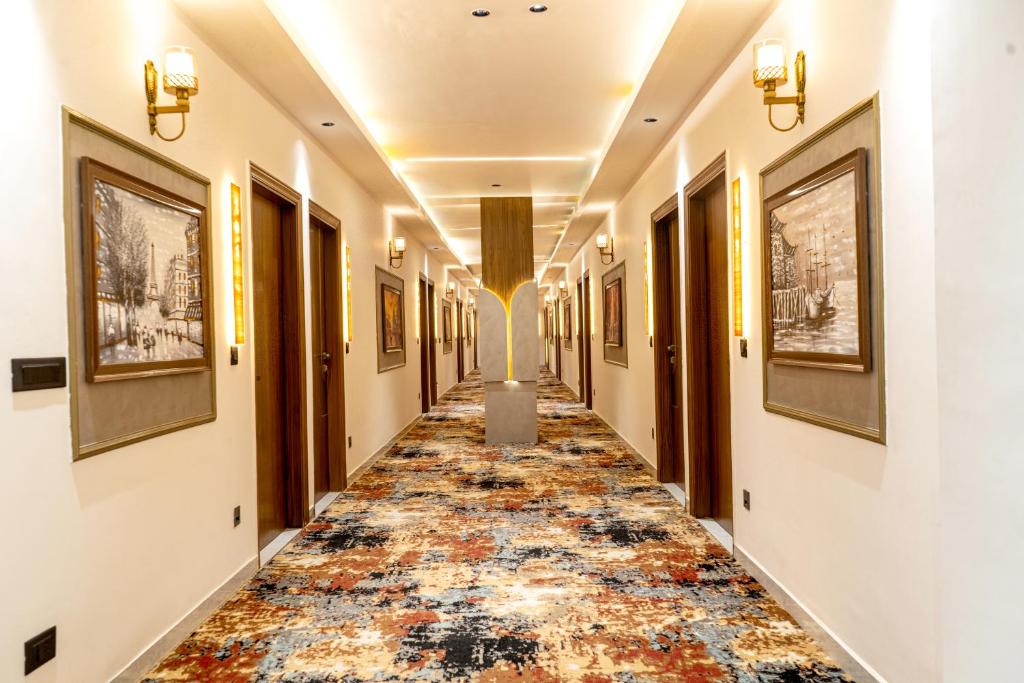 an aisle in a building with a colorful carpet at Hotel Panipat Prime in Pānīpat