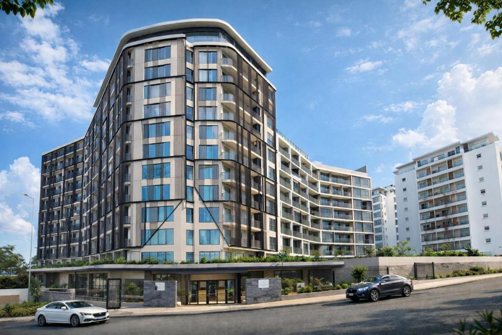 two cars parked in front of a tall building at LoxwoodStudio by UniqueView in Accra