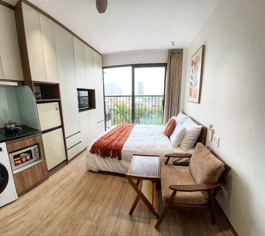 a bedroom with a bed and a table and a couch at Hanoi Aurelia Stay in Hanoi