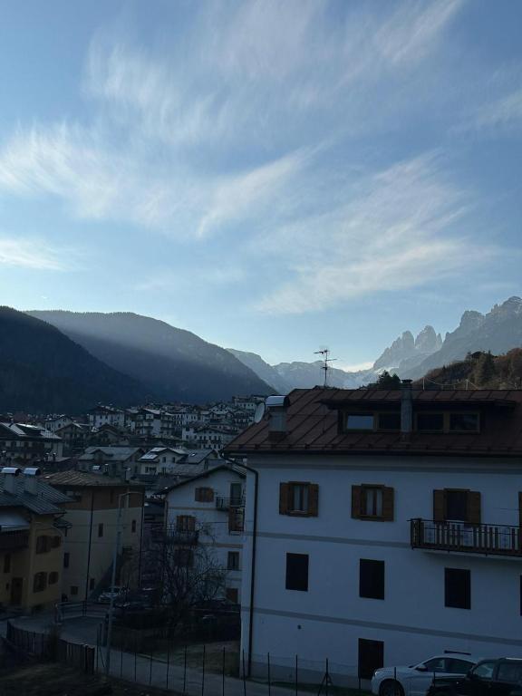 a view of a city with mountains in the background at Calvi's Center Home in Auronzo di Cadore