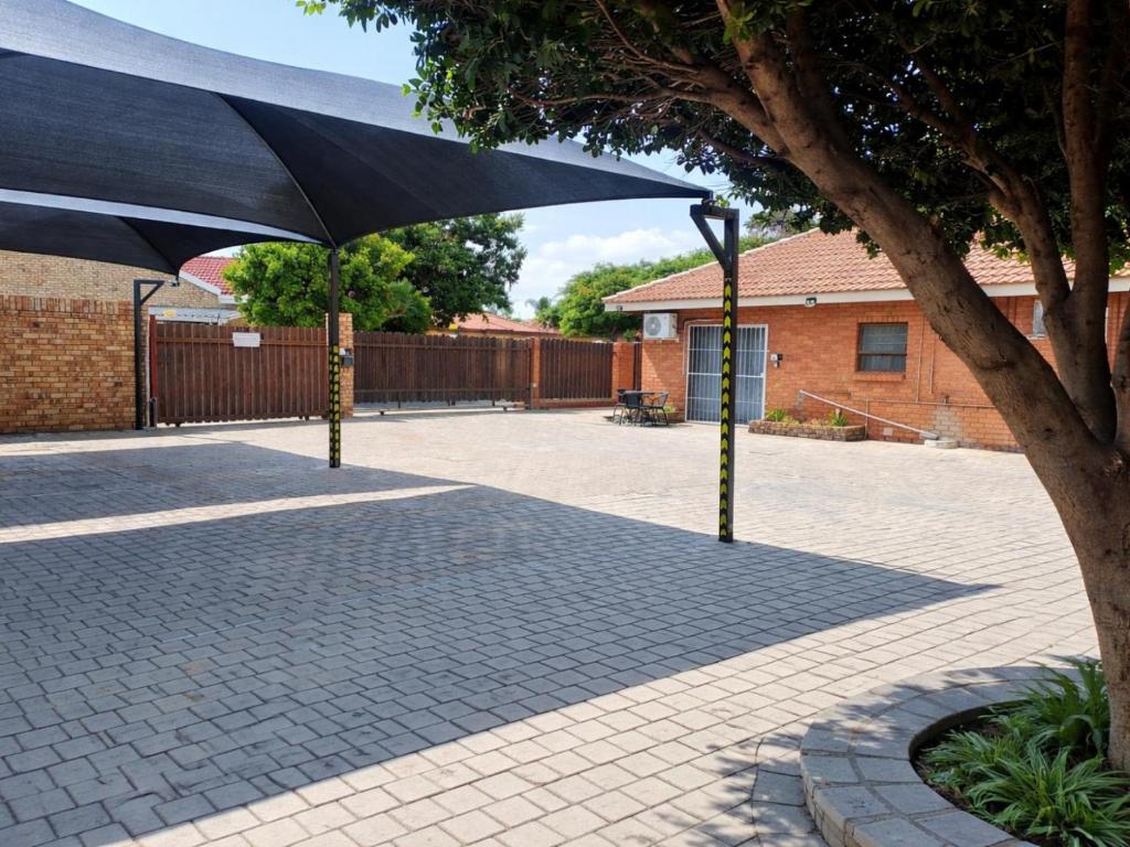 a large black umbrella sitting next to a tree at Hillcrest Hosting AirBnB in Kimberley