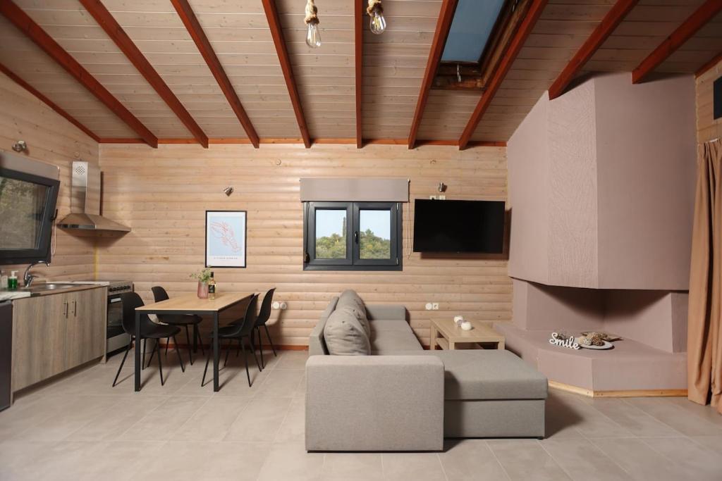a living room with a couch and a table at Hilltop Chalet 5 in Hanioti