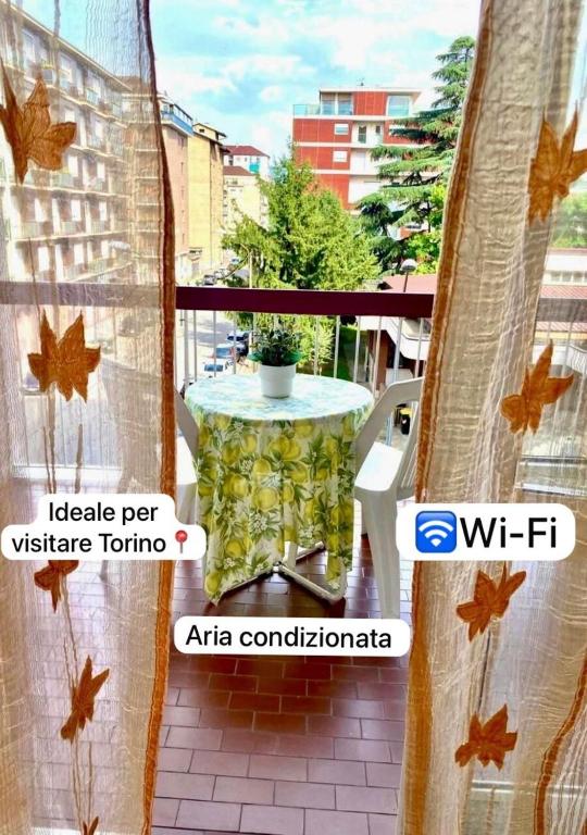 a table on a balcony with a view of a city at 15 minuti al Centro Torino con Tram 4 - Lingotto relax, Inalpi Arena, Stadio in Turin