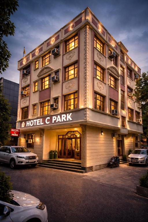 a hotel c park with cars parked in front of it at Hotel C Park, Karol Bagh, New Delhi in New Delhi