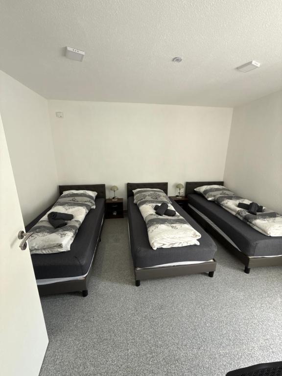 a room with three beds in a room at Team at Home Senden in Senden