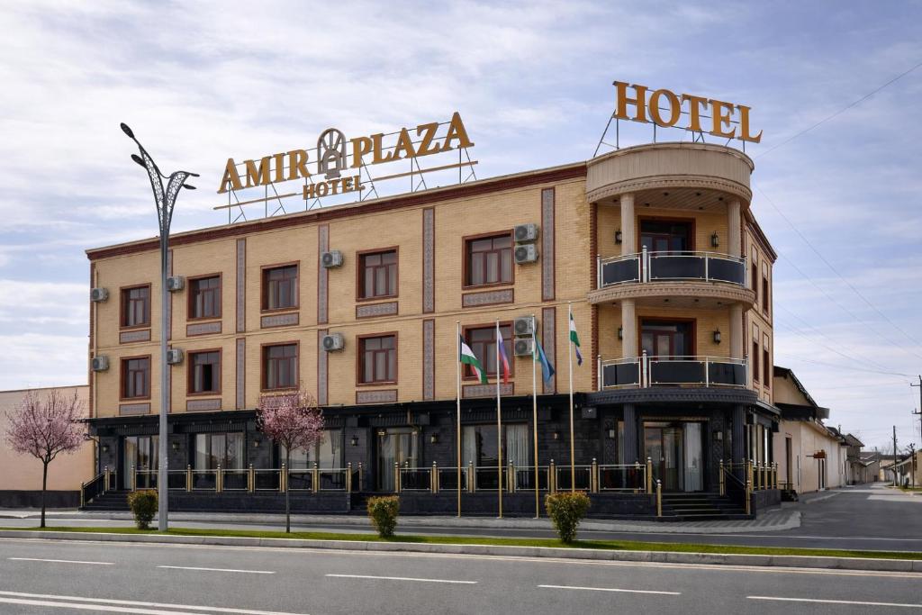 a hotel building with a sign on top of it at AMIR PLAZA hotel in Akmechetʼ