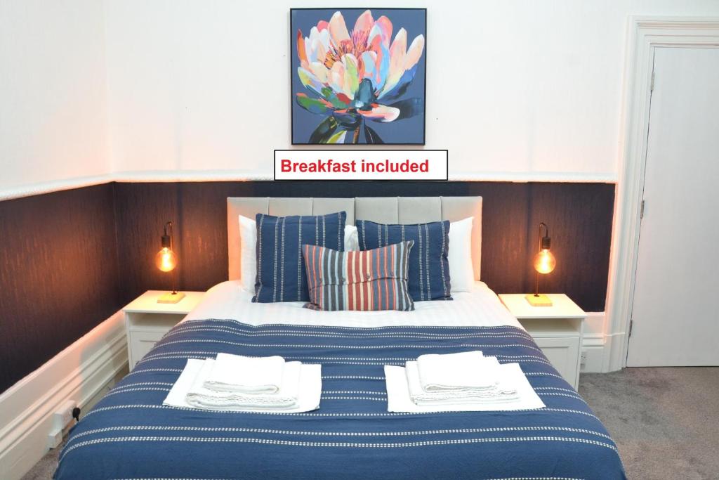 a bedroom with a large bed with two night stands at Manchester Ashton Suites in Ashton under Lyne