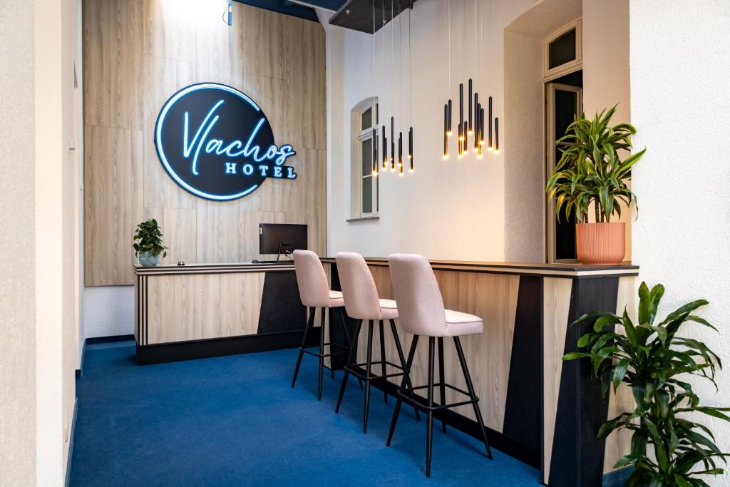 a view of a wales hotel lobby with stools at Vlachos Hotel in Delitzsch