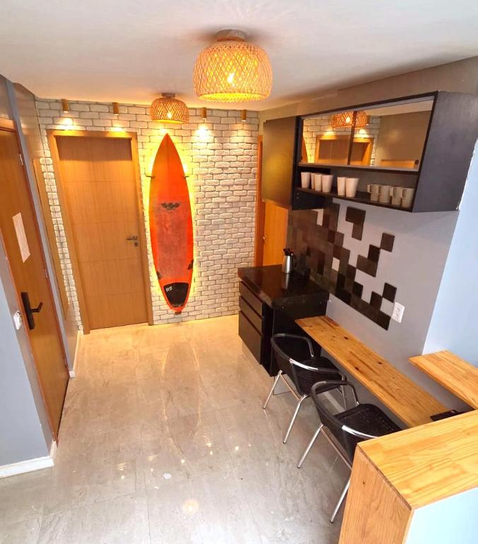 a kitchen with a surfboard hanging on the wall at Salt Beach Atalaia Residence Inn in Salinópolis
