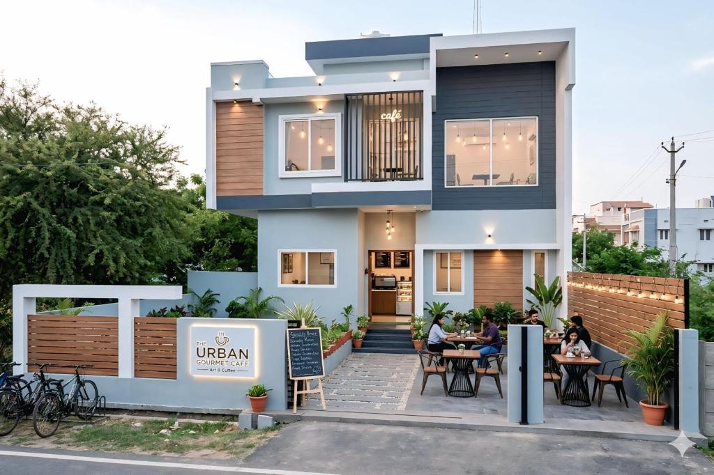 a house with people sitting at tables in front of it at Oasis Fun Villa - Pet Friendly Cafe in Indore
