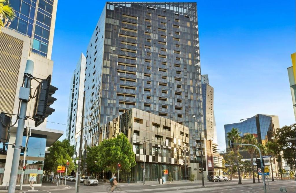 a tall building in the middle of a city at Cozy and Comfortable 2BR Apartment with master Ensuite and bathrooms in Melbourne