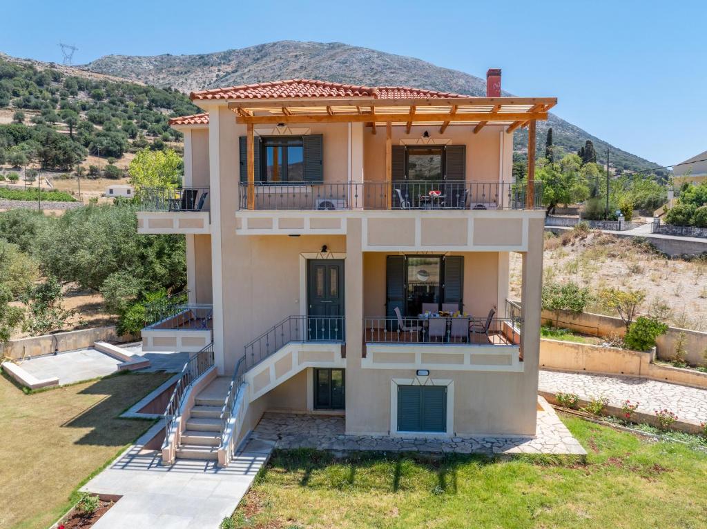 a house with a view of a mountain at Villa Ourania near Myrtos in Divarata