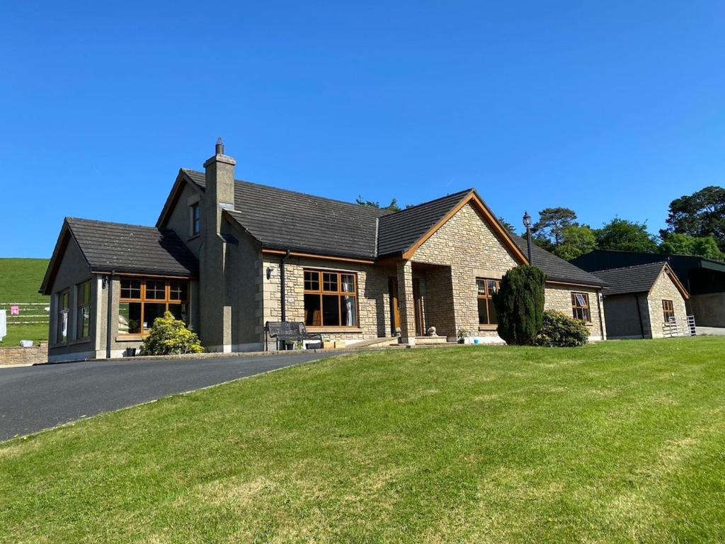 a house with a large lawn in front of it at Hill Farm in Dunmore