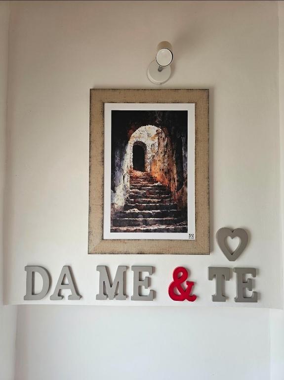 a picture of a stairway with a painting on a wall at Da Me & Te in Ginosa