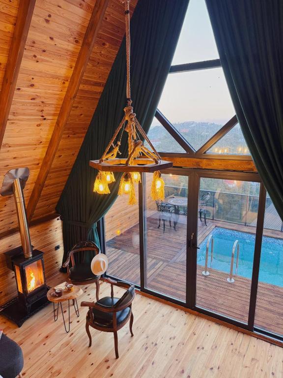 a chandelier hanging in a room with a pool at Defne Bungalow Yomra in Yomra