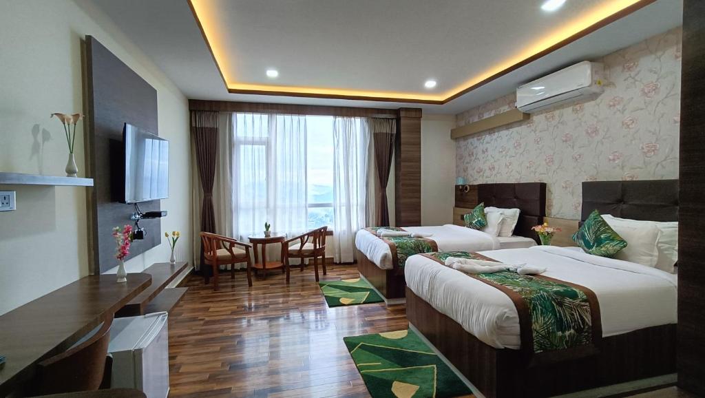a hotel room with two beds and a table and chairs at The Z Retreat & Spa - Swimming Pool & Free Parking - Near Tashi ViewPoint in Gangtok