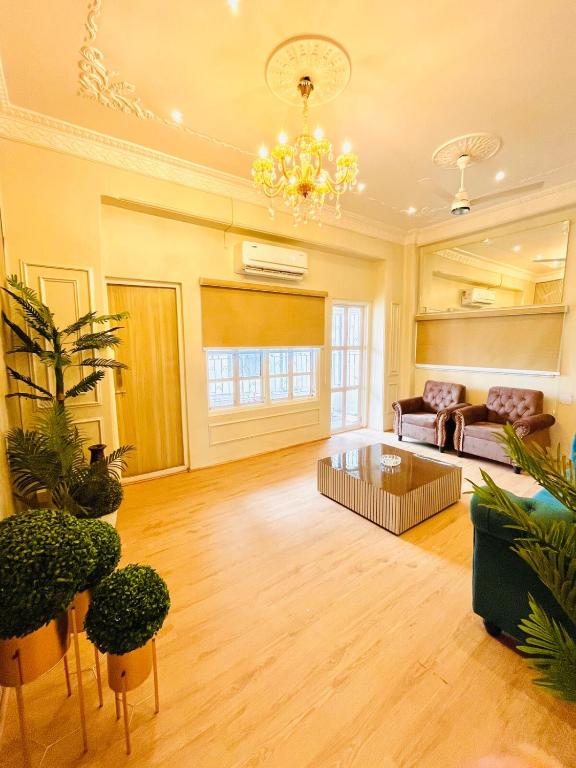 a large living room with a couch and a chandelier at Ballygunge 2BHK 2000sqft flat main road in Kolkata