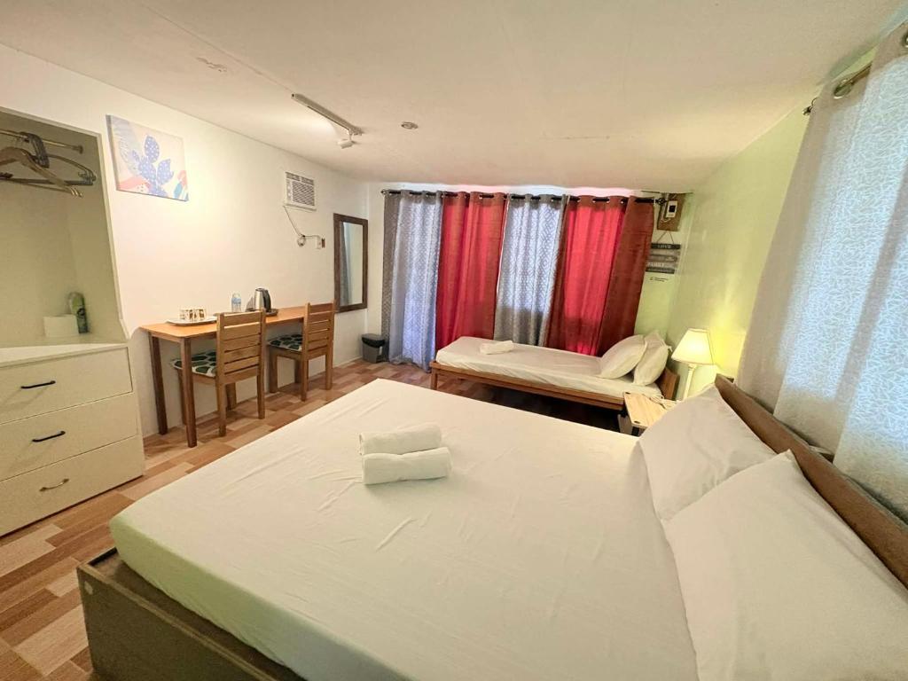 a room with a bed and a desk in it at Island - Escape Homestay in Burgos