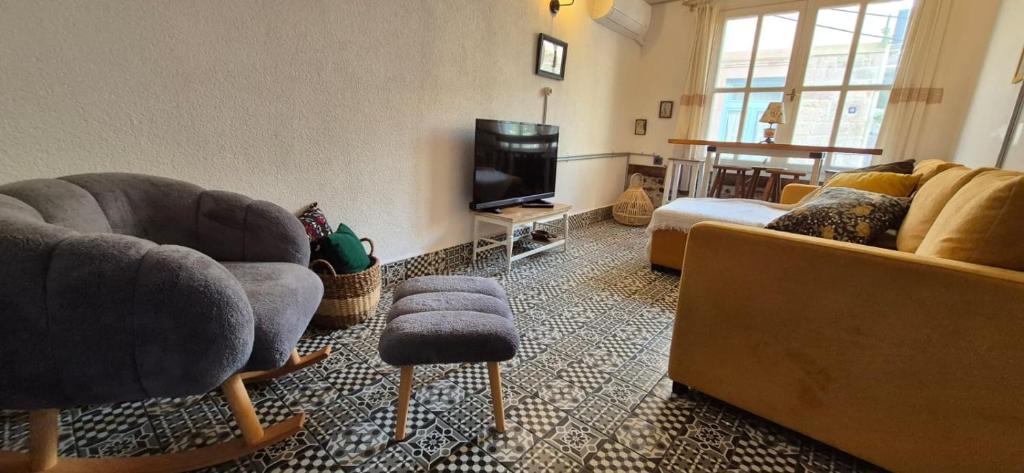 a living room with two couches and a tv at Kelebek Ayvalık in Ayvalık