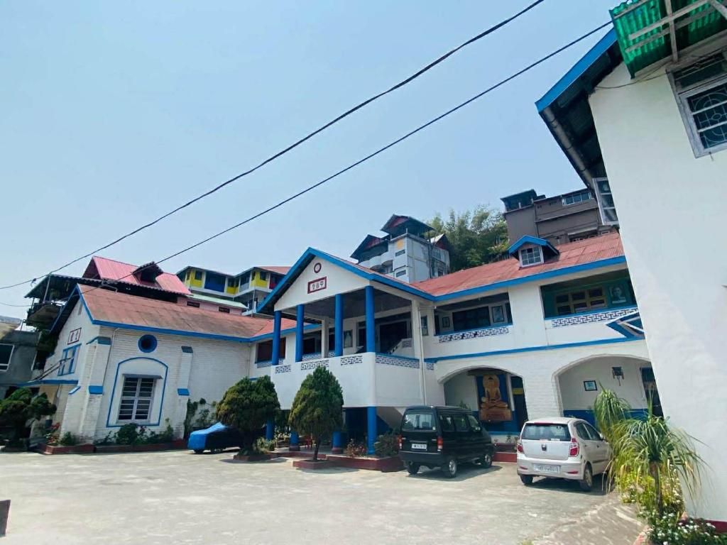 a building with a car parked in a parking lot at Kalimpong Heritage Homestay in Kalimpong
