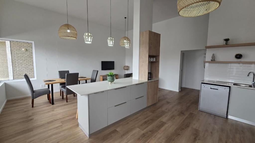 a kitchen and dining room with a table and chairs at NamibStay Swakop Self Catering in Swakopmund