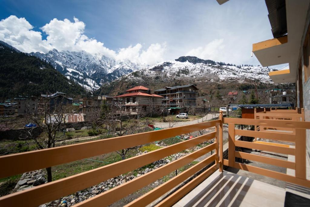 a balcony with a view of a snowy mountain at Jawai Himalayan Cottage in Vashisht