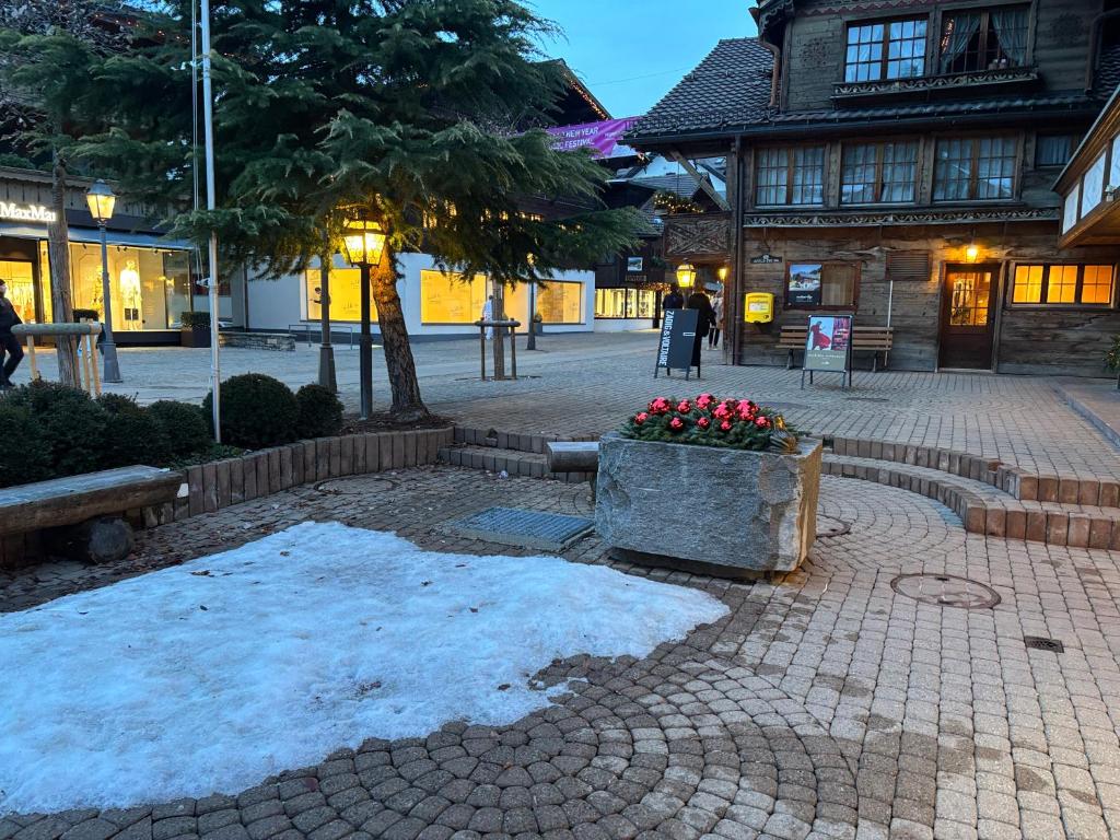 a pile of snow on the ground in front of a building at Le Vieux Chalet in Gstaad