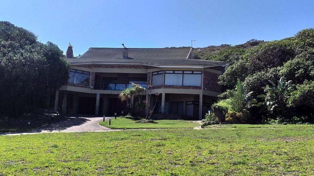 a large house on a hill with a driveway at Dolphin Villa in Gqeberha