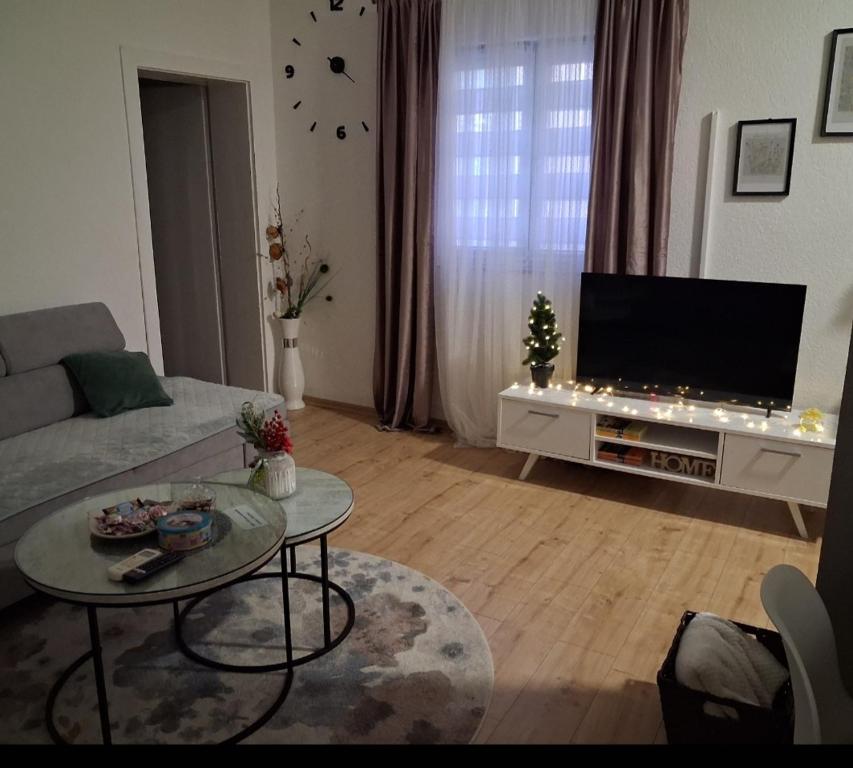 a living room with a couch and a flat screen tv at Apartman Kraljević in Ljubuški