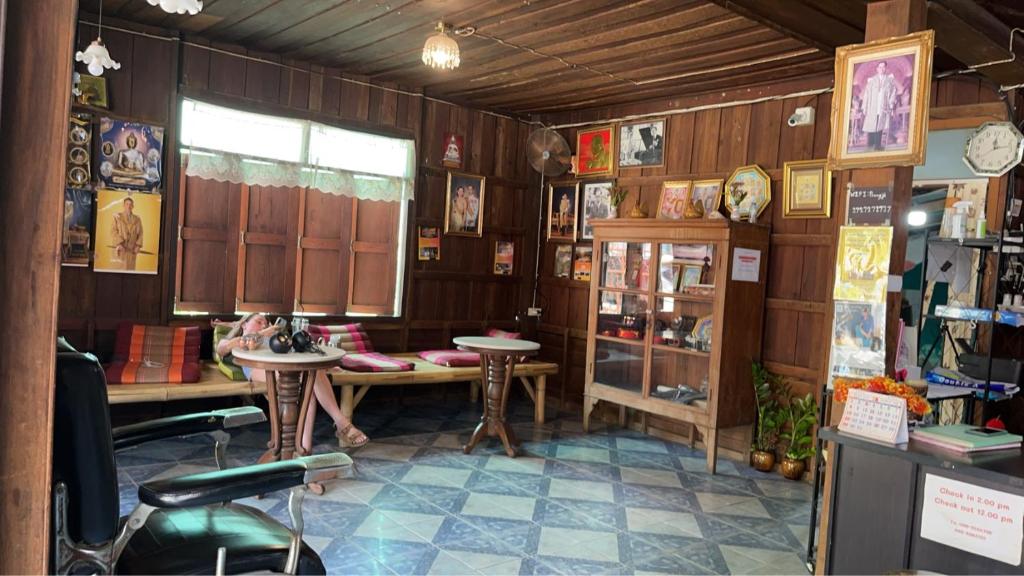 a room with a table and chairs in a store at Baan Pai Hostel in Pai