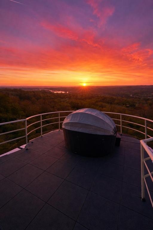 a boat sitting on top of a balcony at sunset at La Tour'angelle in Saint-Étienne-de-Chigny