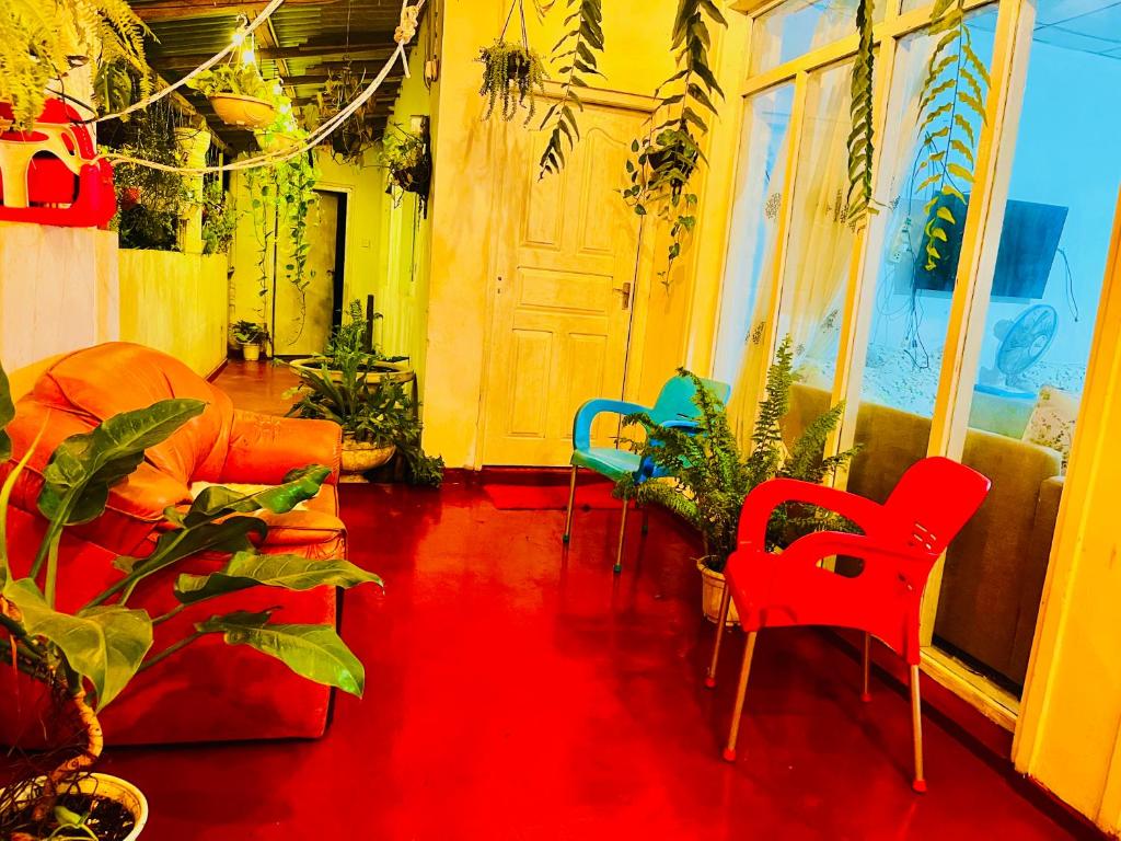 a room with colorful chairs and a door at Peradeniya Inn in Kandy